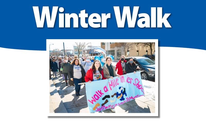 Mother and child walking in the snow
