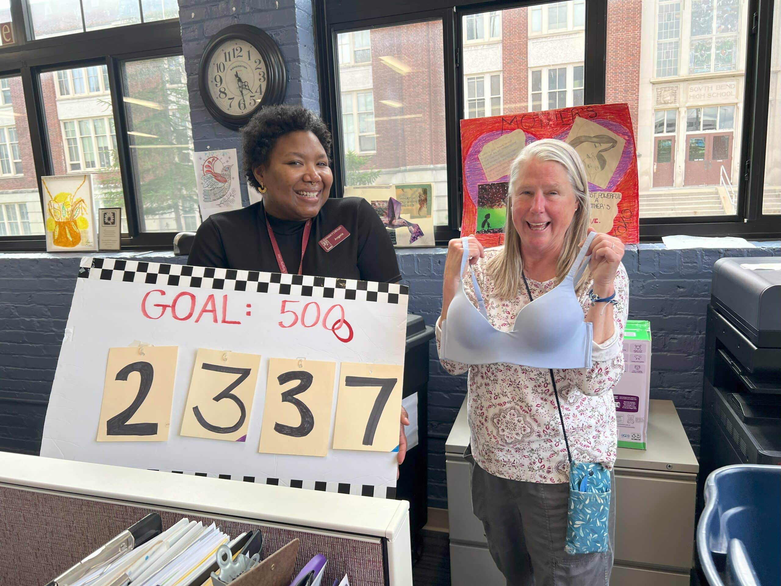 Women holding sign that says Goal: 5000 and the number 2337