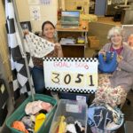 Women holding underwear and a sign that says Goal: 5000 and the number 3051