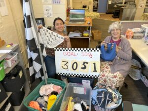 Women holding underwear and a sign that says Goal: 5000 and the number 3051