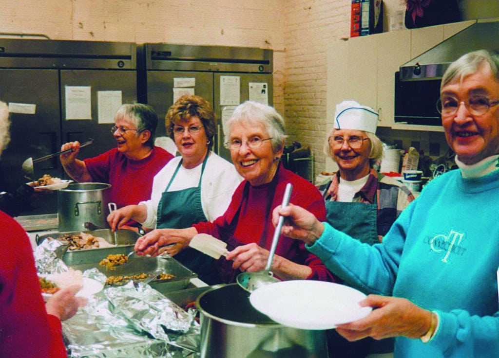 Five women serving lunch in the SMH kitchen