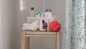 Shower caddy with toiletries sitting on a stool in the shower